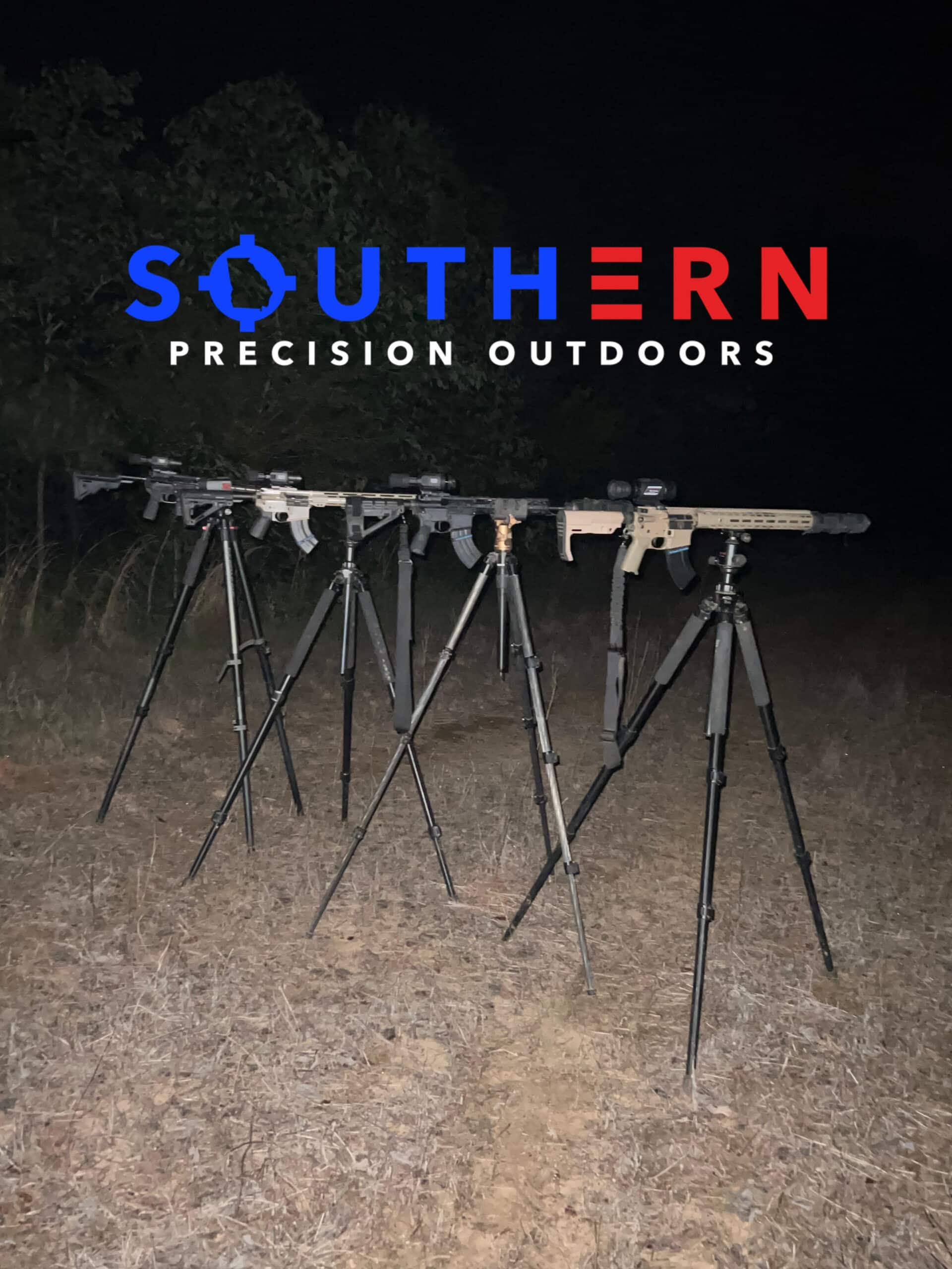 A group of rifle stands in the grass.