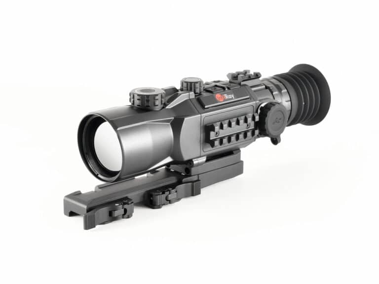 A rifle scope with an attached rail and a sight.