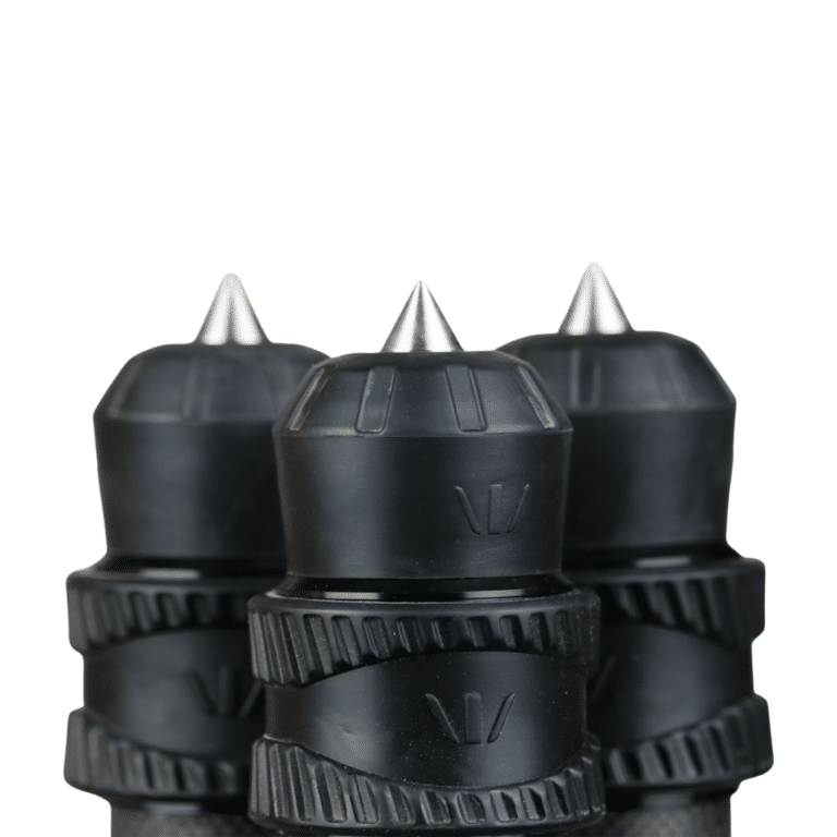 A group of three black plastic bottles with spikes on top.