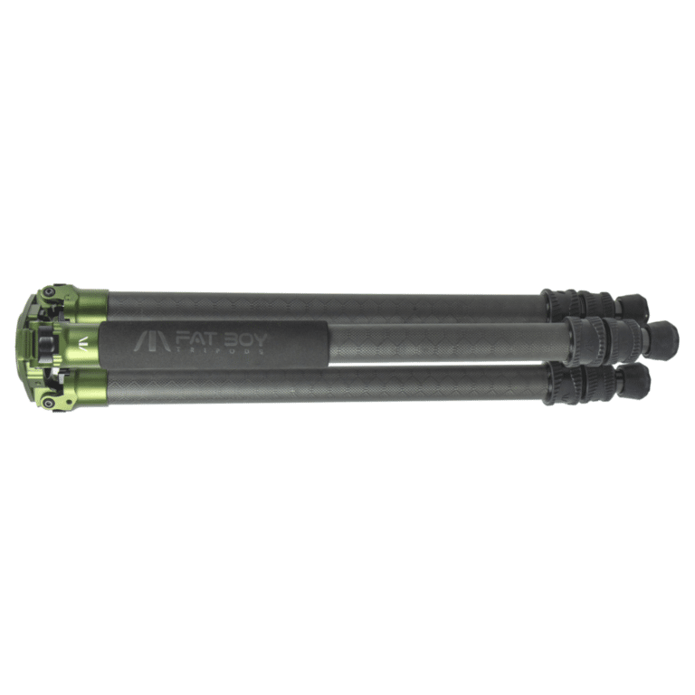 A green and black tripod is sitting on top of the ground.