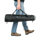 A man holding a bag of equipment in his hand.