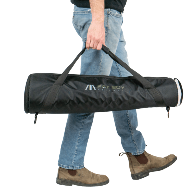 A man holding a bag of equipment in his hand.