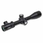 A rifle scope with a green dot on it.