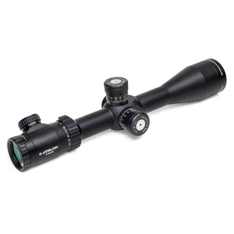 A rifle scope with a green dot on it.