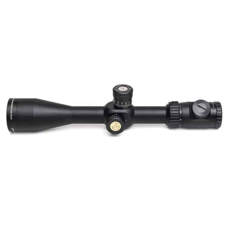 A black rifle scope with a yellow dot on it.