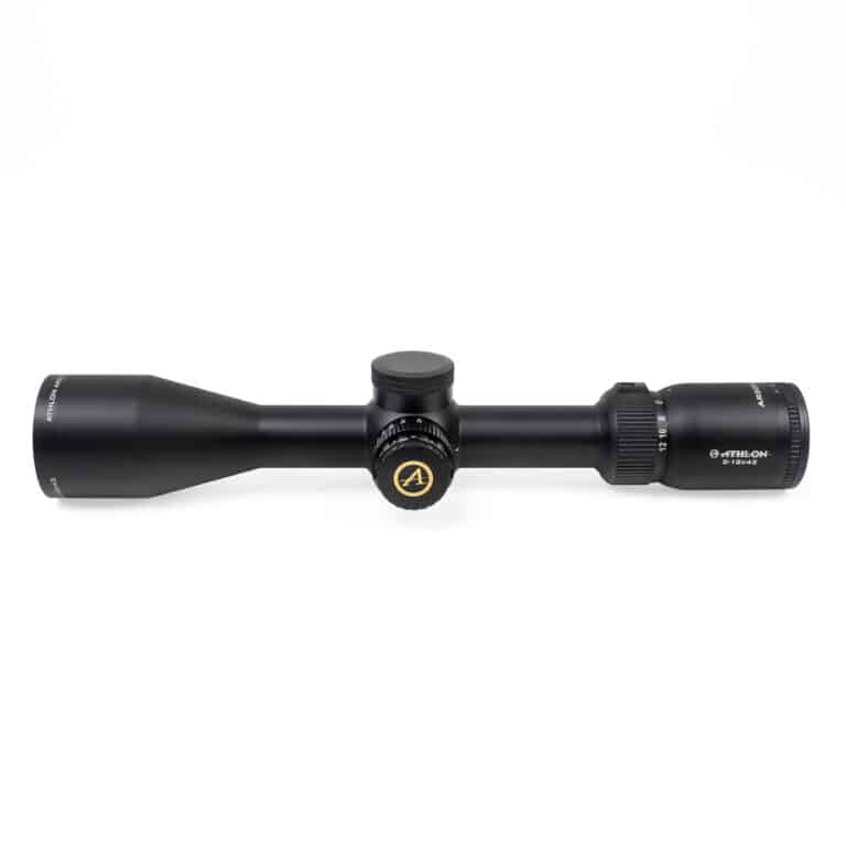 A black rifle scope with a yellow dot on it.