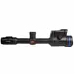 A rifle scope with a blue dot on it.