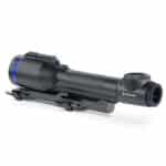 A rifle scope with blue ring on it.