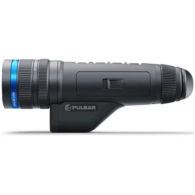 A black and blue flashlight is on the side of a white wall.