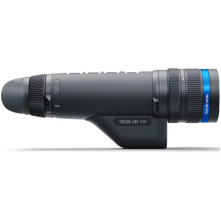 A black and blue camera is on the side of a white wall.