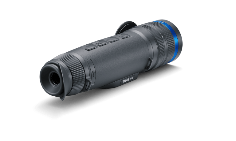 A black and blue camera is on the ground