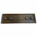 A brown metal plaque with five small magnets.