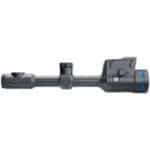 A rifle scope with a blue dot on it.