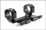 A black scope mount with two different sized rings.