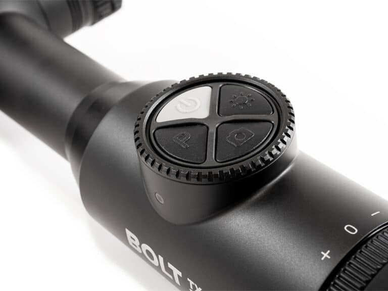 A close up of the scope on a rifle
