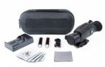 A camera and accessories are laying out on the table.