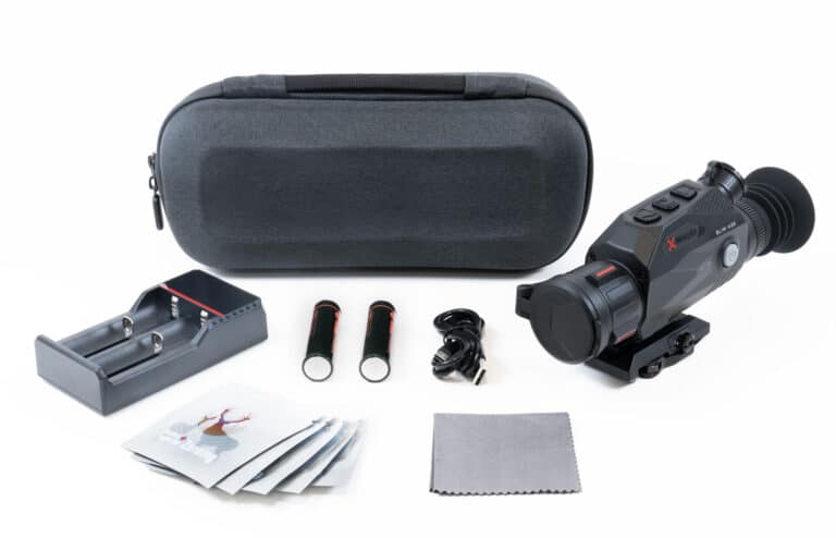 A camera and accessories are laying out on the table.