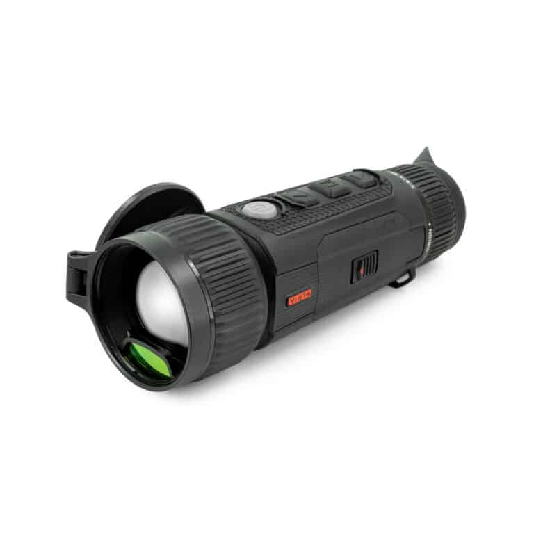 A black flashlight with green light on top of it.
