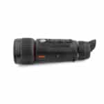 A black and orange camera is on the side of a white background