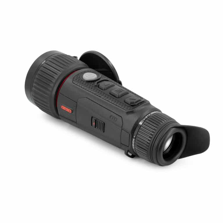 A black and red camera is on the ground