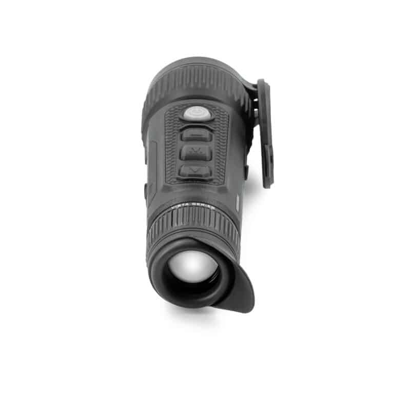 A black flashlight is on the ground.