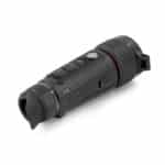 A black flashlight is on the ground.