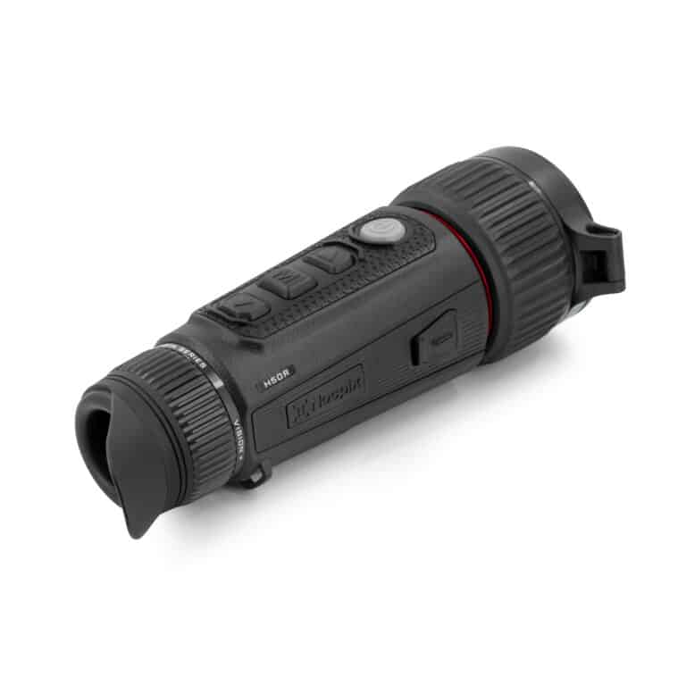 A black flashlight is on the ground.