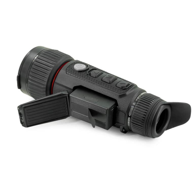 A black and red camera is laying on the ground