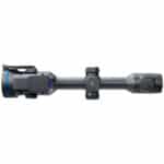 A rifle scope with a blue dot on it.