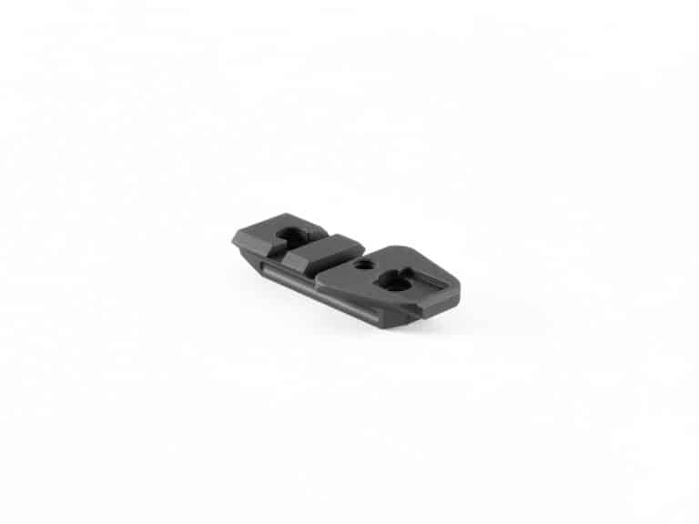 A black piece of metal sitting on top of a white table.