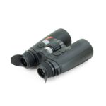 A pair of binoculars with the strap on top.
